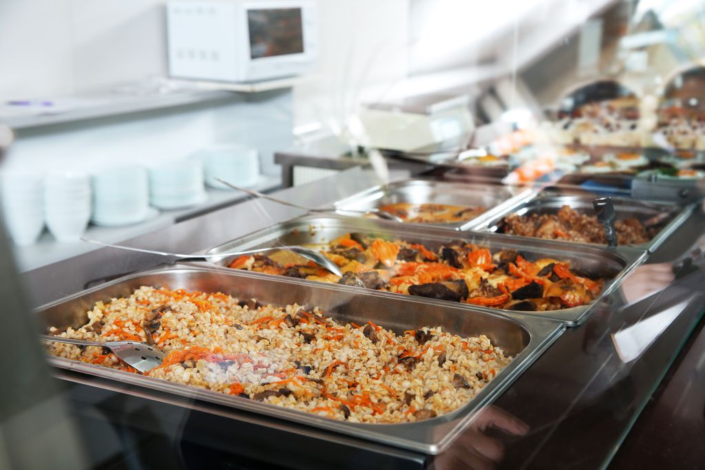 Containers with healthy food in school canteen